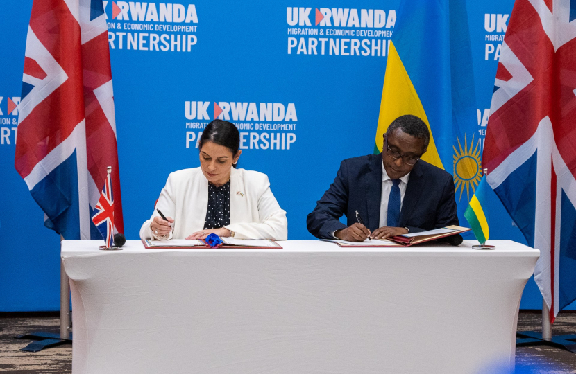 British home secretary Priti Patel (left) and Rwandan foreign minister Vincent Biruta (right) enacting the policy on 14 April 2022